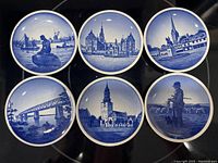 Six blue and white Danish porcelain butter pats illustrating historical landmarks and scenes