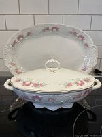 Photo showing white porcelain oval platter with pink floral Bridal Rose pattern and embossed decorative handle edges