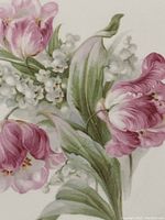Close-up of pink tulips and white lilies of the valley floral design on the plate.