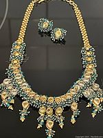 Front view of the vintage lavaliere necklace and matching earrings showing intricate bead and stone details