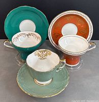 All three teacups arranged side by side with their matching saucers behind.