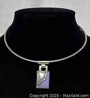 925 silver Mexican choker necklace with purple rectangular pendant and silver wavy design. Shown on black necklace display stand.