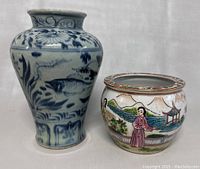 Photo of the blue and white vase and the hand painted planter side by side showing their relative sizes and designs.