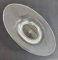 Top angled view of clear oval crystal dish showing overall shape and size.