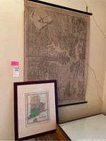 Large hanging Boston map in grayscale showing coastal topography and fortifications, displayed with wooden rails.