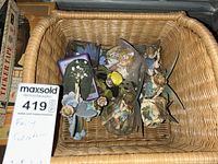Photo of multiple fairy figurines and ornaments inside a wicker basket