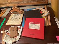 Overview of lot showing books 'Sketches from Japan' and 'Japanese with Pictures', kite frame components, cloth, and other assorted items