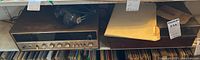 Sansui stereo receiver and record player side by side on shelf