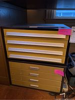 Two stacked metal slide organizer cabinets with beige drawers and white handles, showing front and side views.