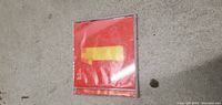 Closed front side of The Beatles One CD jewel case showing red cover with yellow number 1 and 'The Beatles' text.