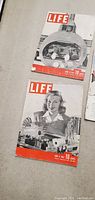 Two vintage Life magazines laid out side by side on a flat surface showing covers with scientific themes, dated to 1940s, 10 cents price on cover.