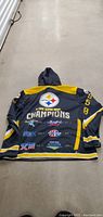 Back view of the Steelers hoodie with multiple Super Bowl championship logos and years embroidered