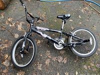 Full view of black BMX bike with Bone Collector graphics and typical BMX features including padded seat and straight handlebars.