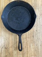 Top view of 9-inch cast iron skillet showing cooking surface with seasoning and signs of use.