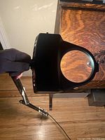 Magnifying lamp showing the clamp and adjustable arm from a top-down angle.