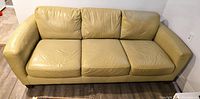 Front view of the three-seater Italian leather sofa, showing three seat and back cushions and overall condition.