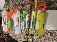 Photo showing all five water toys laid on the floor, including two X-Shot blasters, two Akua Zuka water blasters, and one Hydropower blaster