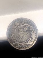 Front side of the coin showing crown, date 1864, 'ONE CENT' and 'NEW BRUNSWICK' text with a wreath surrounding.