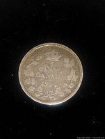 Reverse side of the 1904 Canadian 5 cent silver coin showing the denomination, country, year, and maple leaf wreath design.