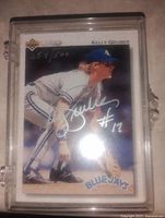 Front view of the signed Kelly Gruber Toronto Blue Jays baseball card in protective case, showing player in fielding stance and silver autograph with number 17, card numbered 254/500.