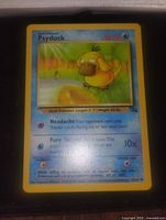 Front image of a Fossil Psyduck Pokémon card showing crisp details, 30 HP, listed moves, and illustration with yellow border.