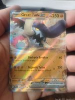Front view of Great Tusk GX Pokemon collectible card showing holofoil, character image, and attack details.