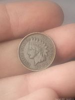 Obverse side of 1904 Indian Head cent showing Liberty with Native American headdress and date.