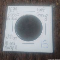 Front side of the coin housed in white cardboard holder with handwritten details showing year 1694, denomination half penny, and monarchs William III and Mary II.
