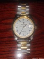 Front view of the Sandoz men's wristwatch showing white dial with Roman numerals and two-tone metal bracelet.