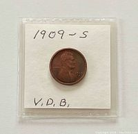 Obverse of 1909-S V.D.B. Lincoln Cent in plastic flip with handwritten label
