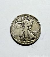 Obverse side of 1929 S Walking Liberty Half Dollar showing Liberty walking, date 1929 and 'In God We Trust'. Coin surface shows circulation wear.