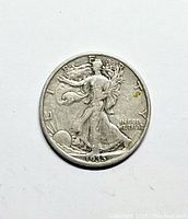 Obverse of 1935 S Walking Liberty half dollar showing Lady Liberty walking towards the sun, with the date 1935 visible at the bottom and the words 'LIBERTY' and 'IN GOD WE TRUST'.