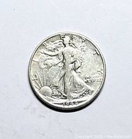 Obverse side of the 1944 D Walking Liberty silver half dollar coin showing Lady Liberty walking with sun rising and date 1944.