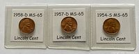 Front side of three Lincoln Wheat Cents dated 1958-D, 1957-D, and 1954-S, each graded MS-65 and encased in protective plastic holders.