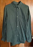 Front view of a green plaid plaid dress shirt by Lands End, showing button-down collar and button front.