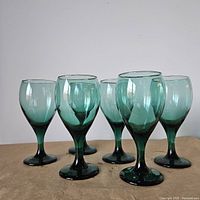 Six vintage green wine glasses arranged in two rows showing overall shape, size, and color.