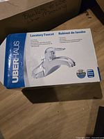 Box of UberHaus lavatory faucet with product image and brand logo visible on packaging