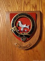Front view of the Oliver Scottish clan crest plaque showing the dove, red felt background, and wooden base with the name Oliver.