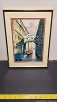 Full view of the framed painting showing Venice canal, Bridge of Sighs, gondola, and buildings.