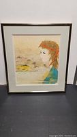 Frontal view of the framed Chigiri-e torn paper art showing the girl's side profile and overall condition of the frame and matting.