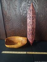 Photo showing the carved burl wood bowl and tribal carved wood shield with measuring scale for reference