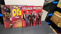 Three vinyl record album covers displayed side by side: Village People Macho Man, Disco Fever, and another disco compilation album with bright colorful design.