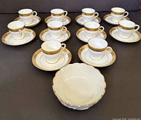 Full set of ten espresso cups and saucers displayed with Lenox nut dish in front