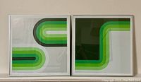 Pair of two framed lithographs with green 1960s style geometric design, displayed side by side.