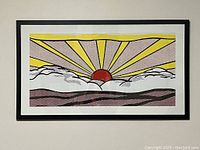 Full view of framed lithographic print with bold yellow sun rays, red sun, black outlines, and clouds in front.