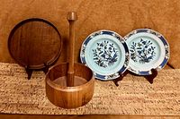 View of the teak plate, paper towel holder, and two Adams Ming Toi Calyx plates all displayed together