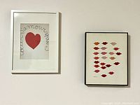 Both framed prints hanging on wall, Warhol lip print on right, Matisse heart and script print on left