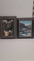 Two framed original paintings by Jack Chivvis displayed side by side: left painting is a boy in woods, right painting depicts a winter lake scene.