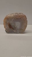 Frontal photo showing the cut face of the geode with visible quartz crystal core and surrounding agate bands.