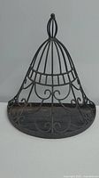 Front view of the cast iron hanging planter showing its dome shape and decorative scrollwork.